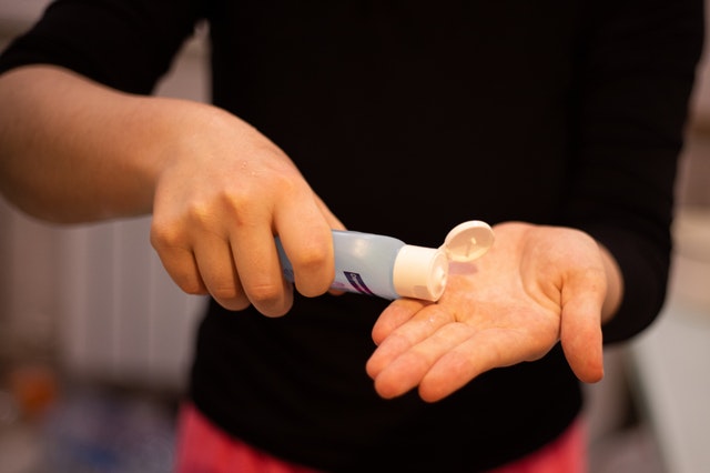 person using hand sanitizer