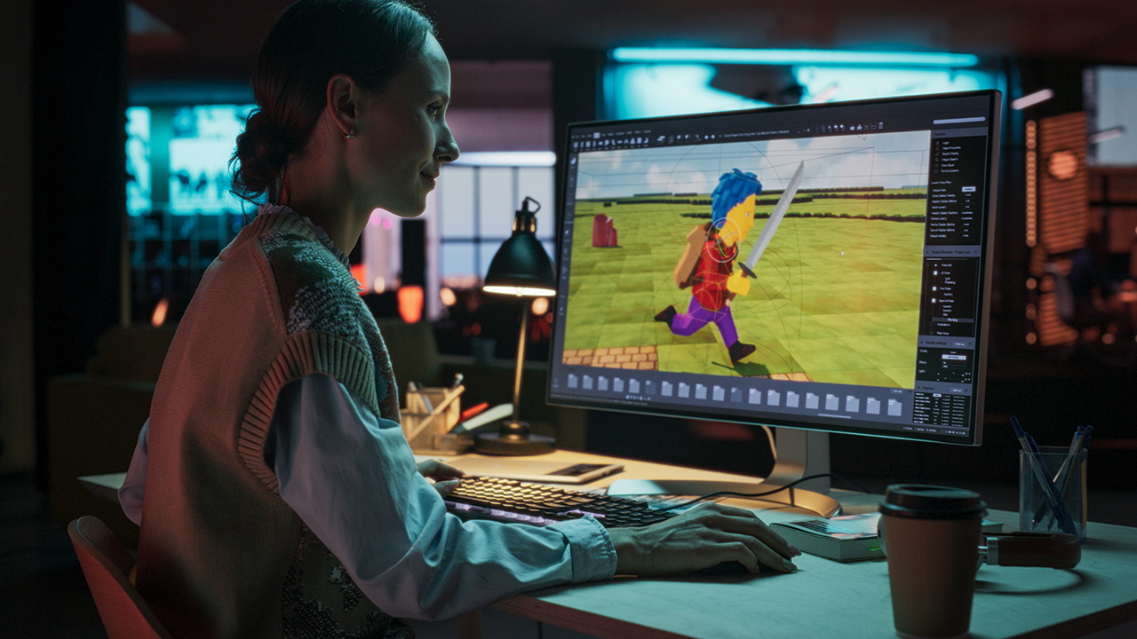 Woman programming her first C++ game on a computer screen